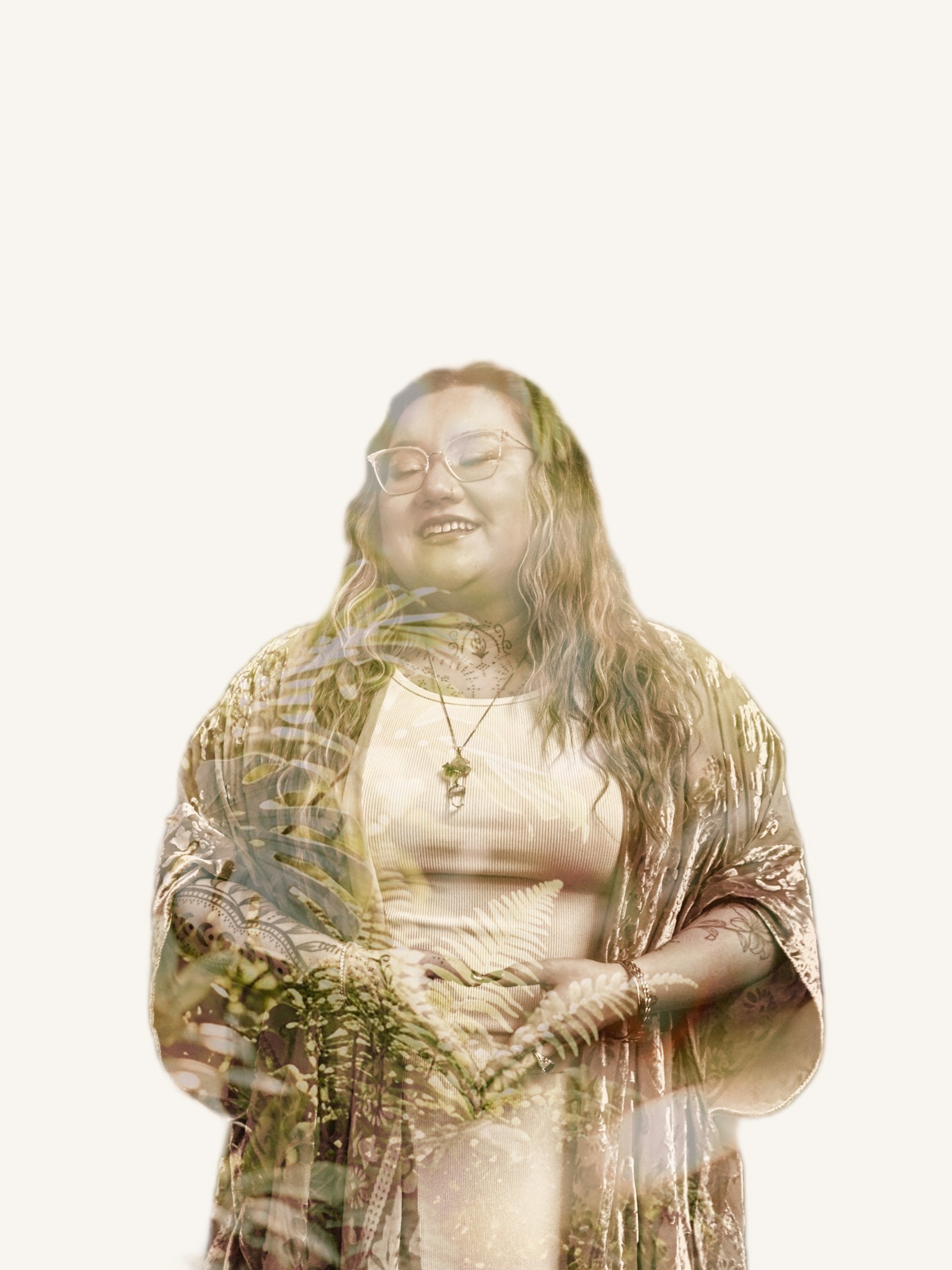 A double-exposure portrait of Xsana Saphire, hands held in a heart — monstera and fern leaves blooming through her form
